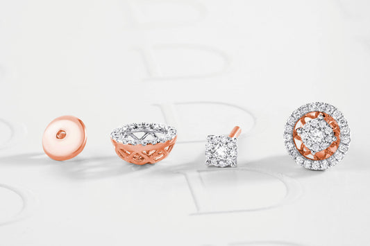Close-up of rose gold and silver diamond stud earrings, featuring different settings including a round and a square design with a halo of small diamonds.