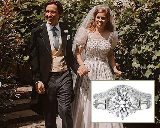 Royal wedding photo of Princess Beatrice and Edoardo Mapelli Mozzi holding hands, smiling with a close-up of the bride's stunning engagement ring featuring a large diamond and diamond-encrusted band.