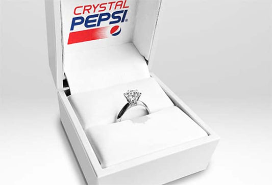 Crystal Pepsi branded ring box displaying a diamond engagement ring, showcasing the unique combination of a vintage beverage logo and luxury jewelry.