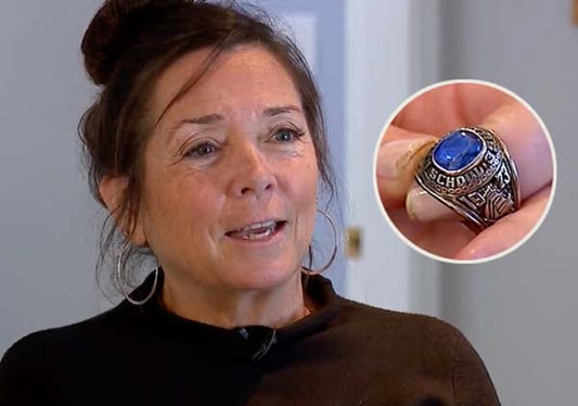 Woman smiling and holding a school ring with a blue stone, showing it close up with a detailed view of the ring.