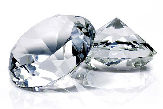 Two sparkling, clear diamonds with brilliant cuts displayed on a white background, showcasing their brilliance and clarity.