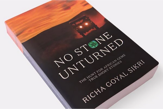 Book cover of 'No Stone Unturned' by Richa Goyal Sikri, featuring an off-road vehicle in the African wilderness and a green gem.