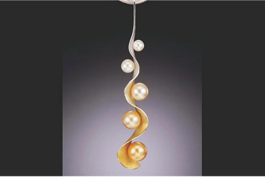 Elegant pearl and gold spiral pendant featuring multiple pearls in a twisting design.