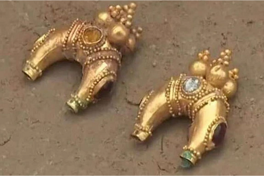 Ancient gold jewelry artifacts with intricate designs and colorful gemstones.