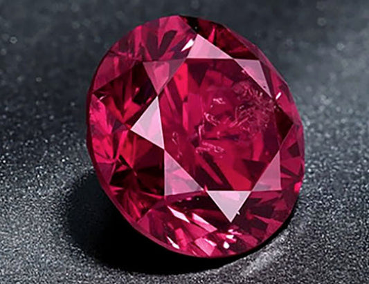 Close-up of a sparkling ruby gemstone with faceted cut.