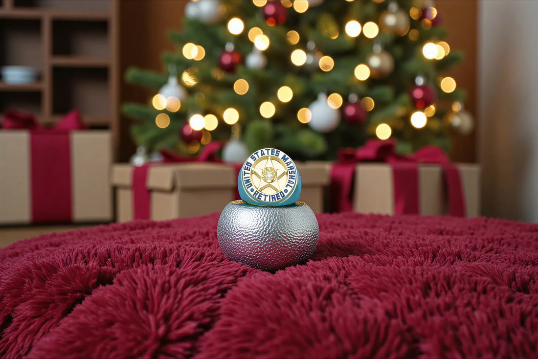 Custom U.S. Marshal retired badge ring displayed on a silver stand in front of a Christmas tree with gifts, photographed for Jewelry Factory holiday gifting.