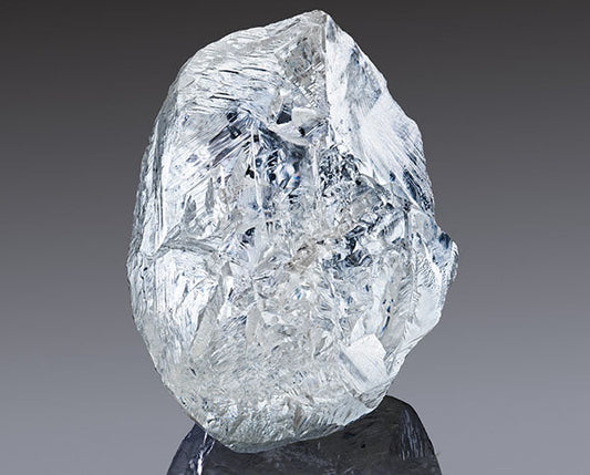 Large, rough diamond crystal with a clear, sparkling appearance, showcasing natural facets.