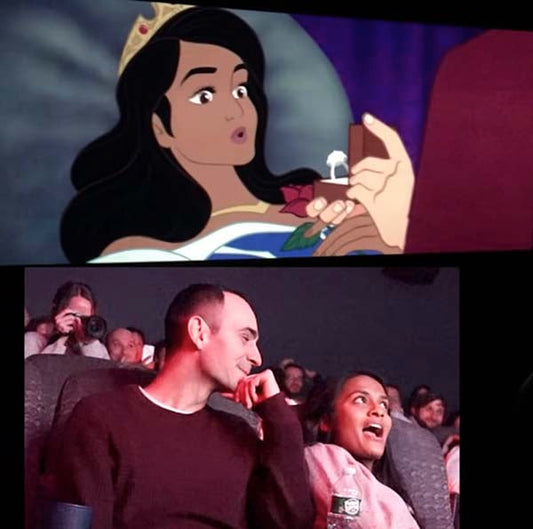 Animation of a princess receiving an engagement ring, with a real-life couple in a movie theater watching the scene and reacting excitedly.