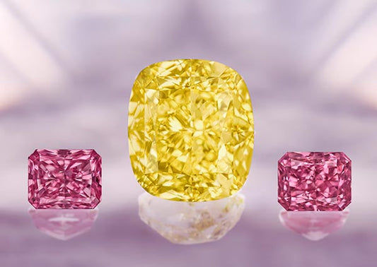 Close-up of three exquisite diamonds, including a yellow diamond in the center surrounded by two pink diamonds, showcasing their sparkling brilliance and unique colors.