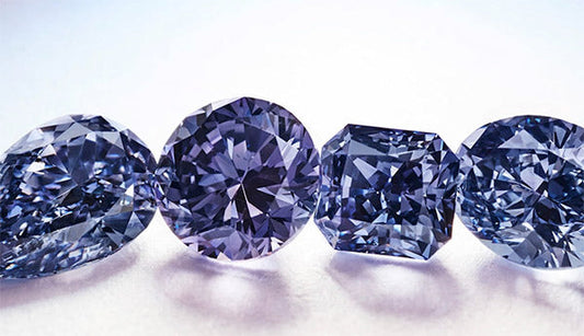 Four exquisite purple diamonds in various cuts, including round and square, displayed on a soft light background, highlighting their brilliant sparkle.