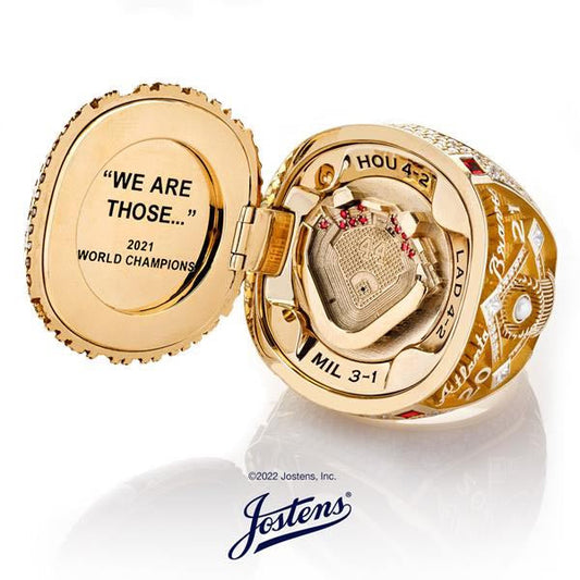 Close-up of a 2021 World Championship ring from Jostens with the inside inscription 'We Are Those...', showcasing the engraved team playoff results: HOU 4-2, LAD 4-2, MIL 3-1.