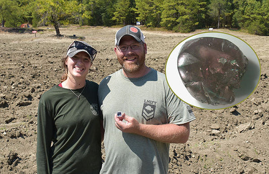 Man and woman smiling and holding a gemstone they found in a field, with an inset image of the gemstone showing its details.