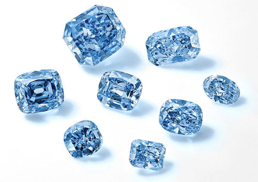 Collection of blue diamonds in various cuts, showcasing their sparkle and clarity.