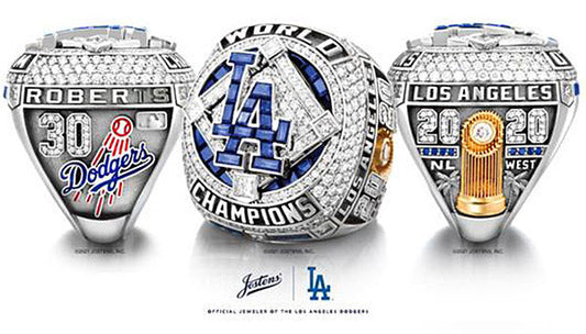 2020 Los Angeles Dodgers World Series championship rings featuring diamonds, 'Roberts' and 'Los Angeles' engravings, with the Dodgers logo and trophy.