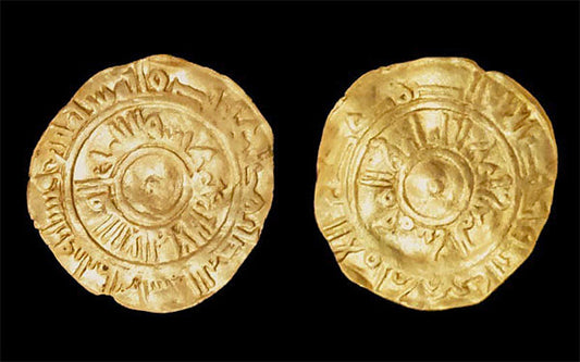 Ancient gold coin featuring intricate inscriptions and a sunburst design on both sides, dating back to historical times.
