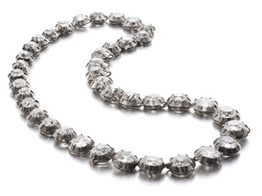 Diamond necklace with multiple sparkling stones set in silver, arranged in an elegant chain.