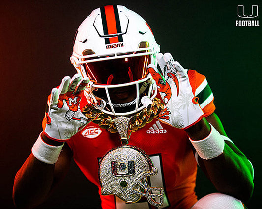 Miami football player wearing an orange jersey, white helmet, and a large gold chain with a Miami Hurricanes pendant, posing with gloves in front of a vibrant background