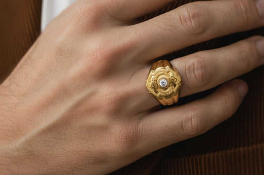 Hand wearing a gold police badge style ring with a central diamond, detailed engraving, and bold signet design symbolizing service and honor.