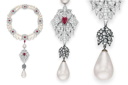 Elegant pearl and diamond necklace with ruby accents, featuring a drop-shaped pearl pendant and detailed diamond leaf motifs.