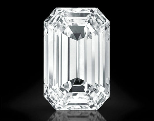 Close-up of a large, clear emerald-cut diamond with multiple facets, reflecting light against a black background.