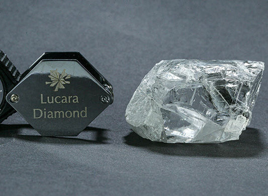 Lucara Diamond logo next to an uncut rough diamond showing its natural form.