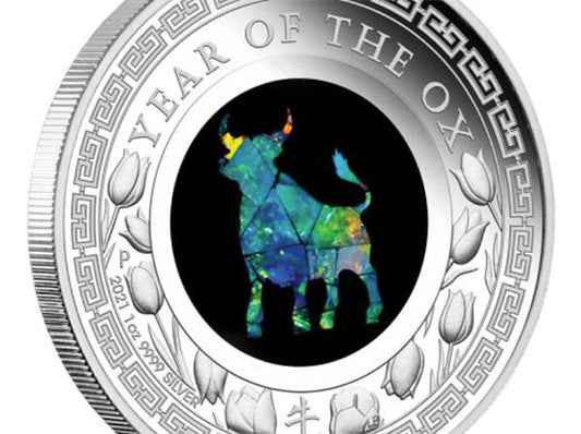 2021 Year of the Ox silver coin featuring a colorful opal inlay of an ox silhouette, with intricate floral patterns around the edge.