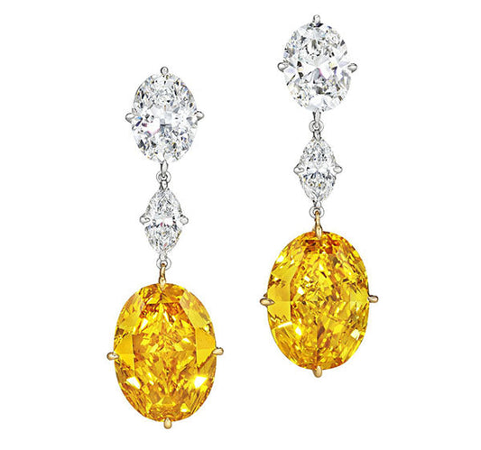 Elegant yellow diamond drop earrings with a sparkling white diamond at the top, featuring oval and pear-shaped stones set in white gold.