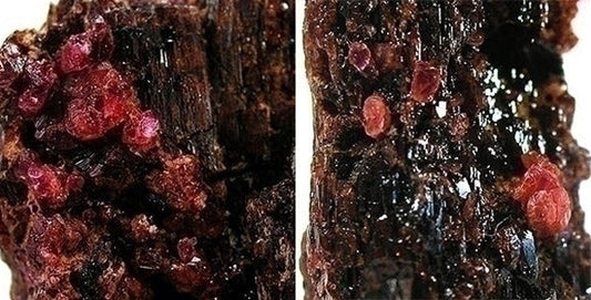 Close-up image of rough Tourmaline gemstone crystals with pinkish-red color embedded in dark matrix, highlighting the intricate texture and natural formation of the minerals.