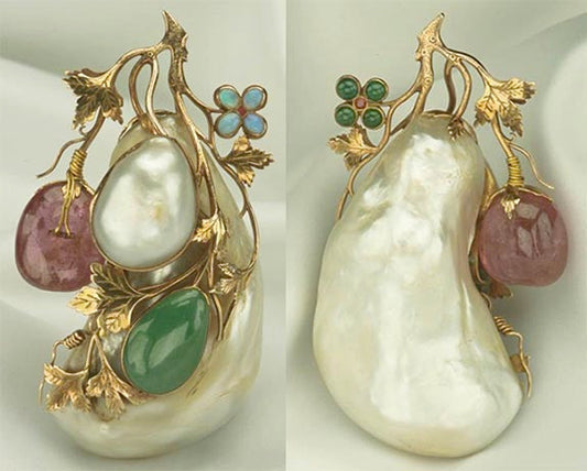 Vintage gold brooch featuring a large pearl surrounded by emerald, pink quartz, and opal stones, with delicate leaf and flower accents in a floral design.