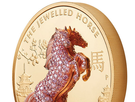 Close-up of a jeweled coin featuring a detailed horse design encrusted with pink diamonds, with the inscription 'The Jewelled Horse.