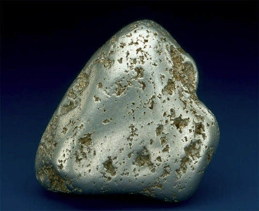 Close-up of a metallic rock with a rough surface, showcasing natural mineral formations and texture.