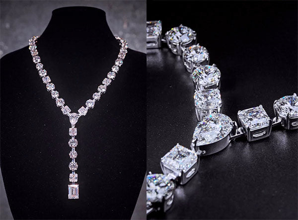 Close-up of a luxurious diamond necklace with rectangular and square-cut diamonds, displayed on a black velvet stand.