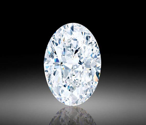 Close-up of a sparkling oval-cut diamond, showcasing its brilliance and clarity against a black background. The diamond reflects light, highlighting its fine facets and pristine quality.