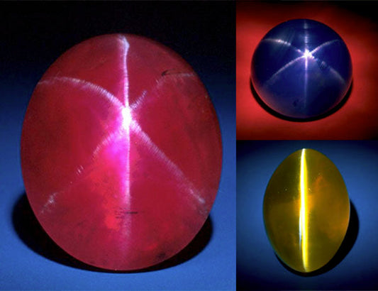 Close-up of three stunning star sapphires in red, blue, and yellow, showcasing their distinct star-like reflections on the surface, demonstrating the unique asterism effect seen in these precious gemstones.