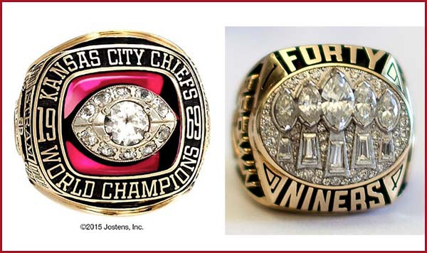 Close-up of two championship rings: the Kansas City Chiefs 1969 World Championship ring with a prominent diamond, and the San Francisco 49ers Super Bowl ring with multiple diamonds set in gold, both featuring detailed engravings.
