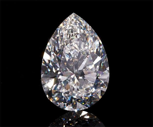 Large pear-shaped diamond with sparkling facets on a black background, showcasing brilliance and clarity.