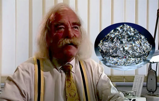 Jeweler with a white mustache discussing diamond craftsmanship, with a close-up of a sparkling, flawless diamond in the foreground.