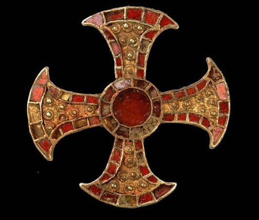Ancient gold and red mosaic cross with intricate stone and bead details, displayed on a black background.