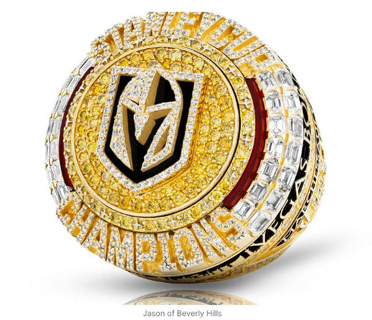 Close-up of a luxury Stanley Cup championship ring with yellow and white diamonds, featuring the Vegas Golden Knights logo.