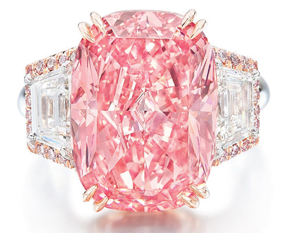 Luxury pink diamond engagement ring featuring a large cushion-cut center stone with triangular side diamonds and a rose gold setting.