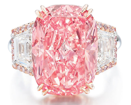 Luxury pink diamond engagement ring featuring a large cushion-cut center stone with triangular side diamonds and a rose gold setting.